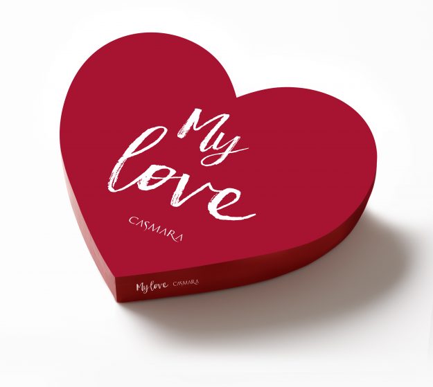 Isolated shot of red heart shape box on white background