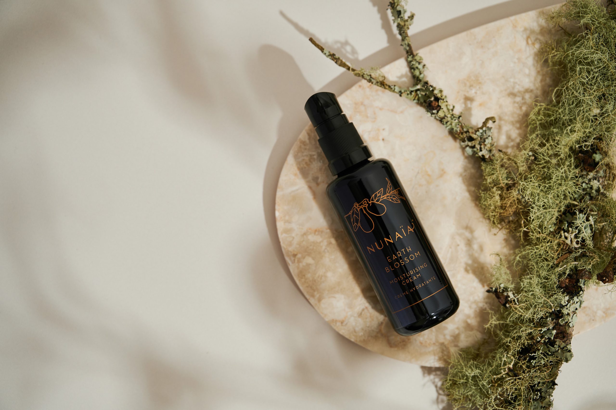 Nunaia Beauty Earth Blossom Moisturising Cream with branch lifestyle image ©Nunaia Beauty 2025